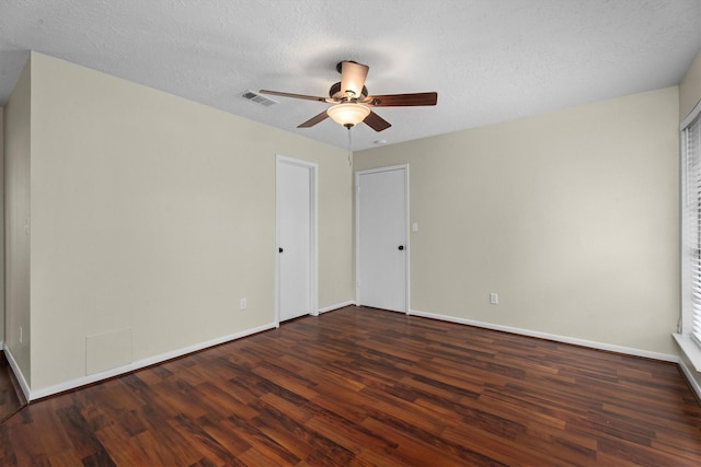 interior space featuring dark hardwood / wood-style flooring, ceiling fan, and a textured ceiling