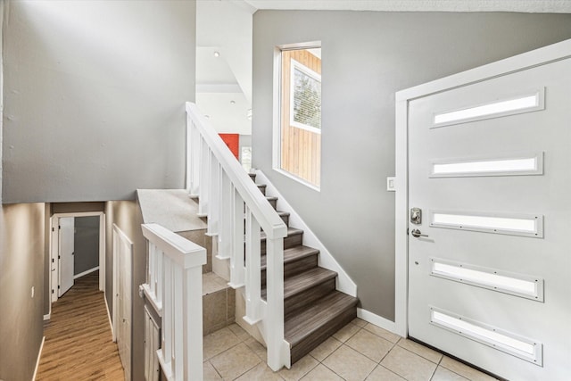 tiled foyer entrance with lofted ceiling