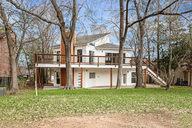 back of house with a yard and a deck