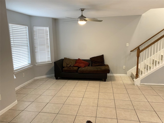 tiled living room with ceiling fan