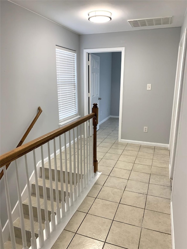 hall featuring light tile patterned floors