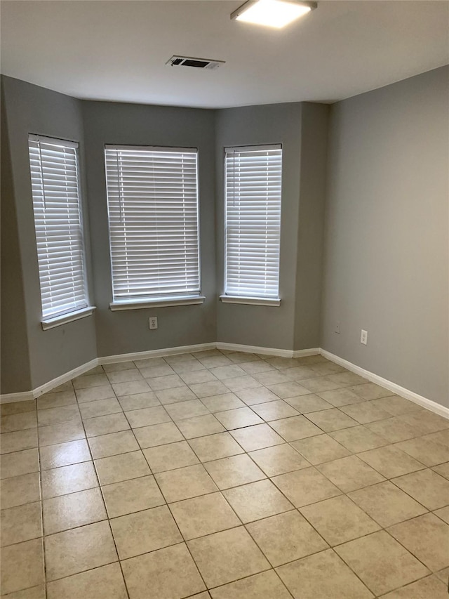 unfurnished room featuring light tile patterned flooring