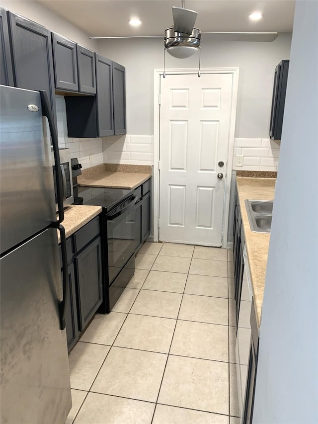 kitchen featuring light tile patterned floors, decorative backsplash, sink, and appliances with stainless steel finishes