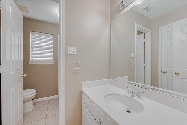 bathroom featuring vanity, tile patterned floors, and toilet