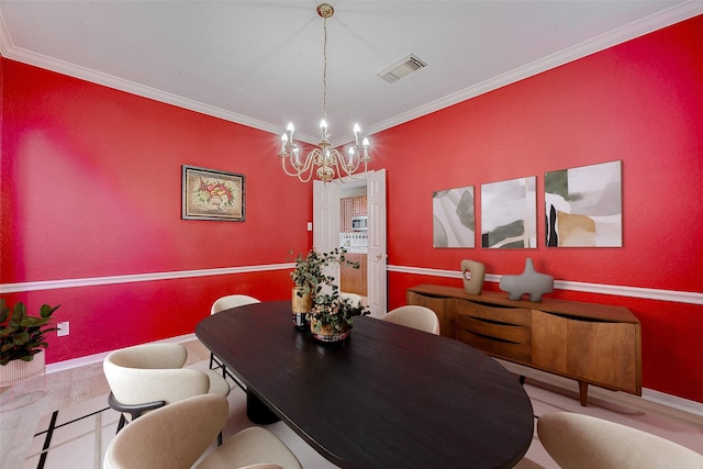 dining room featuring crown molding, an inviting chandelier, and light wood-type flooring