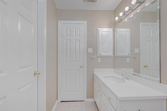 bathroom with tile patterned flooring and vanity