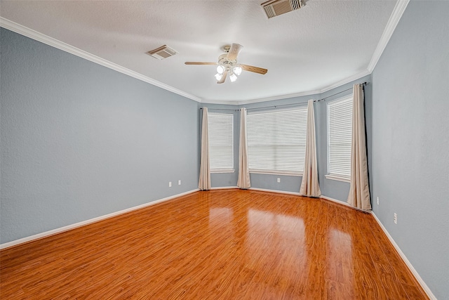 empty room with crown molding, wood-type flooring, a textured ceiling, and ceiling fan