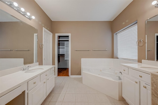 bathroom featuring vanity, tile patterned floors, and a bathtub