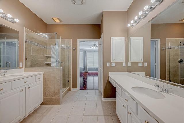 bathroom with tile patterned flooring, vanity, and a shower with shower door