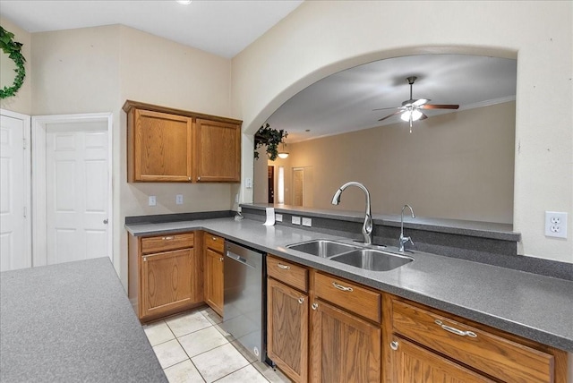 kitchen featuring dishwasher, sink, light tile patterned floors, ceiling fan, and kitchen peninsula