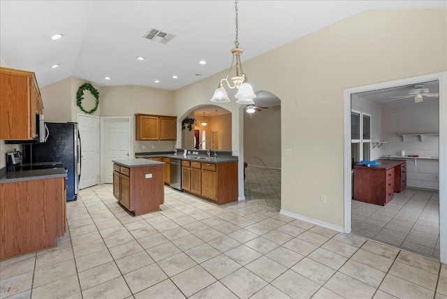 kitchen featuring pendant lighting, ceiling fan, a kitchen island, light tile patterned flooring, and vaulted ceiling