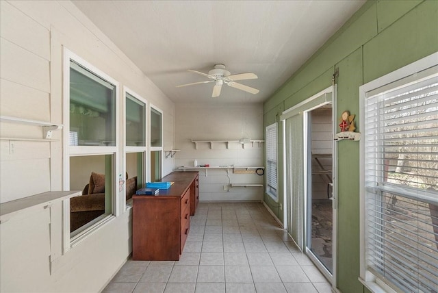 interior space featuring light tile patterned flooring and ceiling fan