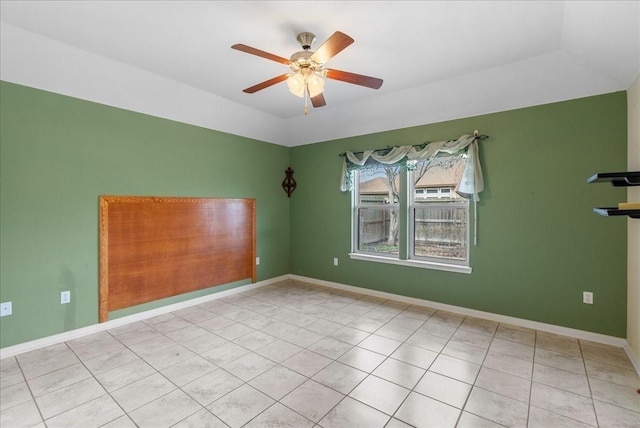 tiled spare room with ceiling fan