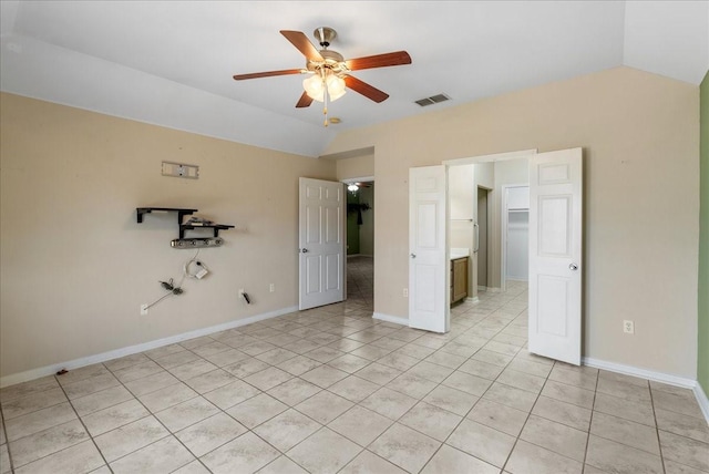 unfurnished bedroom with ceiling fan, vaulted ceiling, and light tile patterned floors