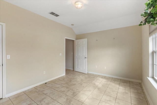 unfurnished room featuring lofted ceiling