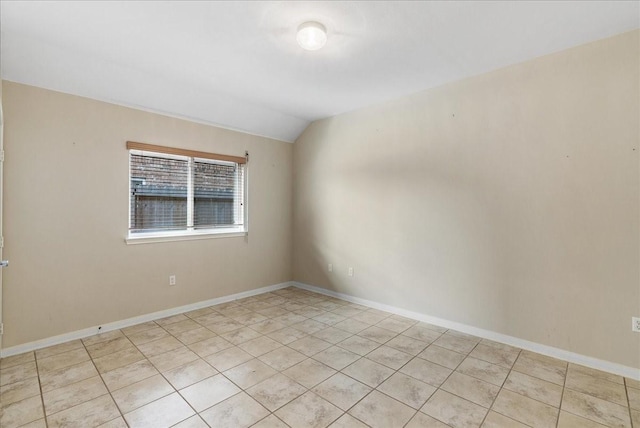 unfurnished room with vaulted ceiling