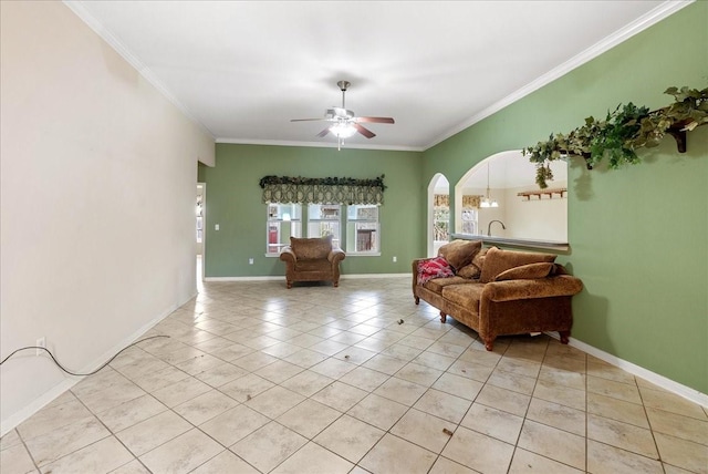 tiled living room with ornamental molding and ceiling fan