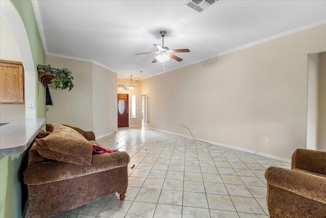 tiled living room with crown molding and ceiling fan