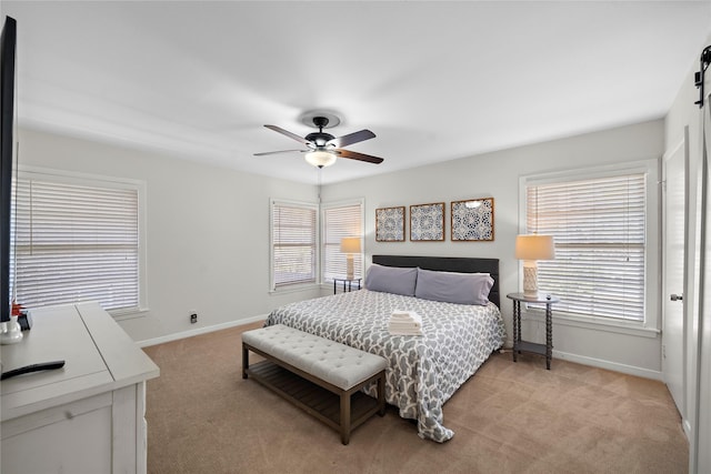 carpeted bedroom featuring multiple windows and ceiling fan