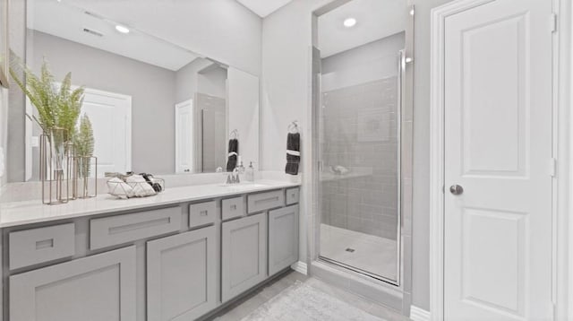 bathroom featuring recessed lighting, a shower stall, visible vents, and vanity