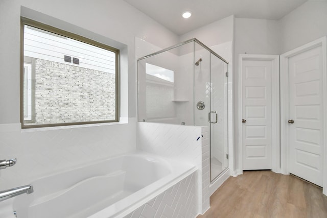 bathroom featuring wood-type flooring and independent shower and bath