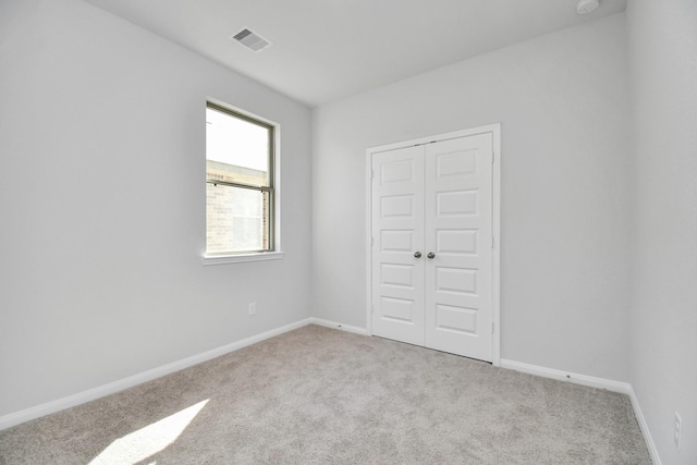 spare room with light colored carpet