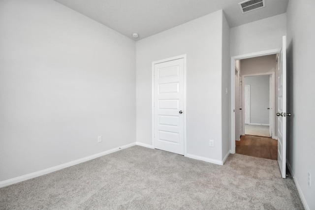 unfurnished bedroom featuring light colored carpet