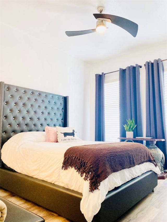 bedroom with wood-type flooring and ceiling fan