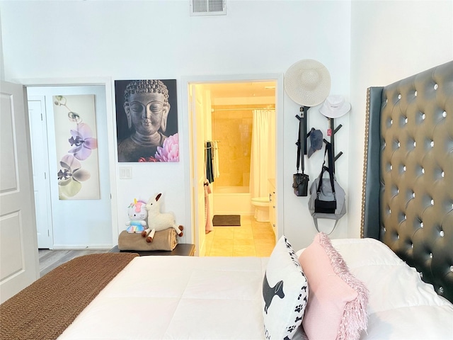 bedroom featuring tile patterned flooring and ensuite bathroom