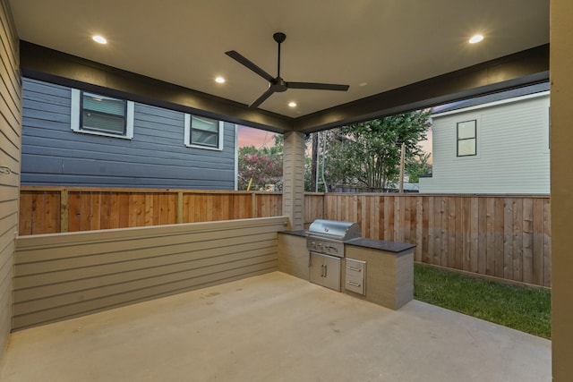 view of patio with grilling area, ceiling fan, and an outdoor kitchen