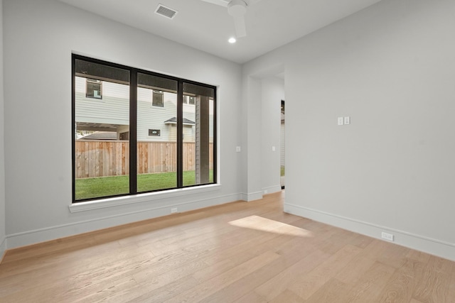 spare room featuring light hardwood / wood-style floors and ceiling fan