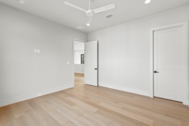 spare room featuring light hardwood / wood-style floors and ceiling fan