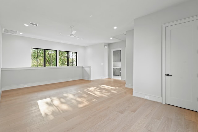 spare room featuring light hardwood / wood-style floors and ceiling fan