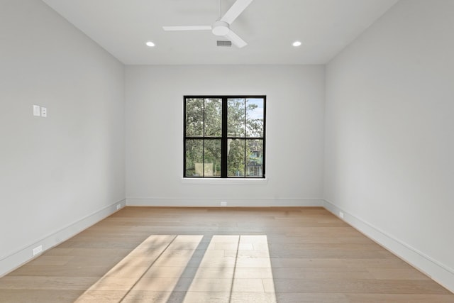 empty room featuring light hardwood / wood-style flooring and ceiling fan