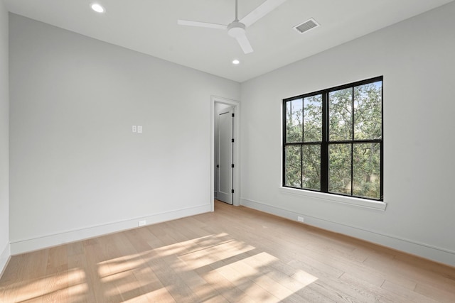 empty room with ceiling fan and light hardwood / wood-style flooring