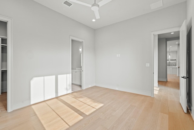 unfurnished bedroom featuring ceiling fan, ensuite bath, and light hardwood / wood-style flooring