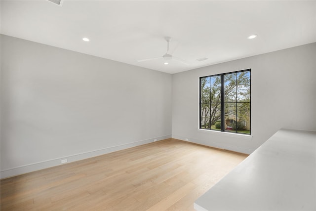 unfurnished room featuring ceiling fan and light hardwood / wood-style flooring