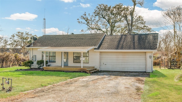 single story home with a garage, a front yard, and a porch