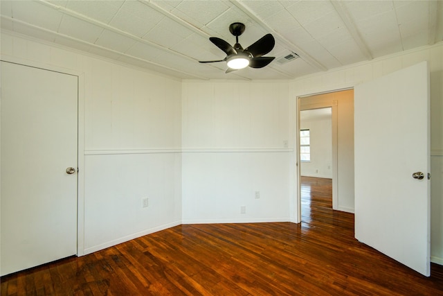 unfurnished room with ceiling fan and dark hardwood / wood-style flooring