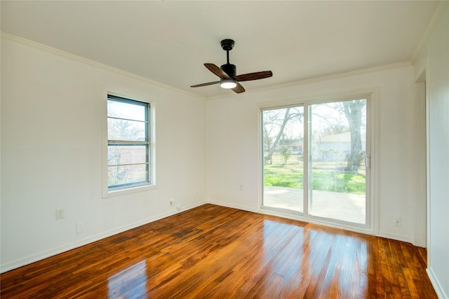 empty room with ornamental molding, dark hardwood / wood-style floors, and ceiling fan