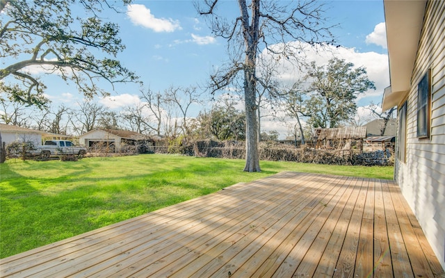 wooden deck featuring a yard