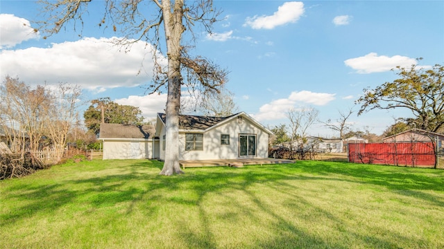 rear view of house with a yard