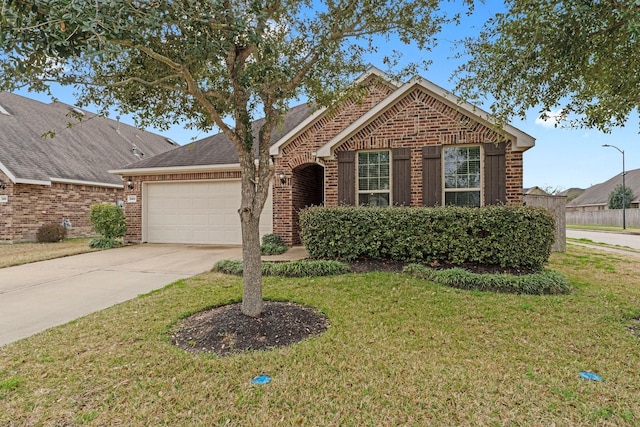 view of front of property featuring a garage and a front yard