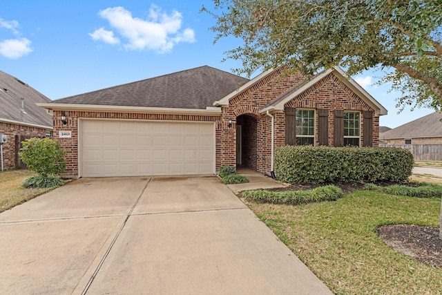 ranch-style home with a garage and a front yard