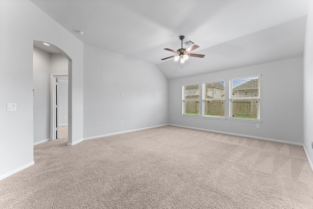 unfurnished room with ceiling fan, carpet flooring, and vaulted ceiling