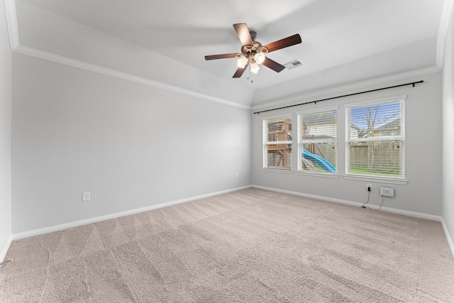 carpeted empty room featuring ornamental molding, vaulted ceiling, and ceiling fan