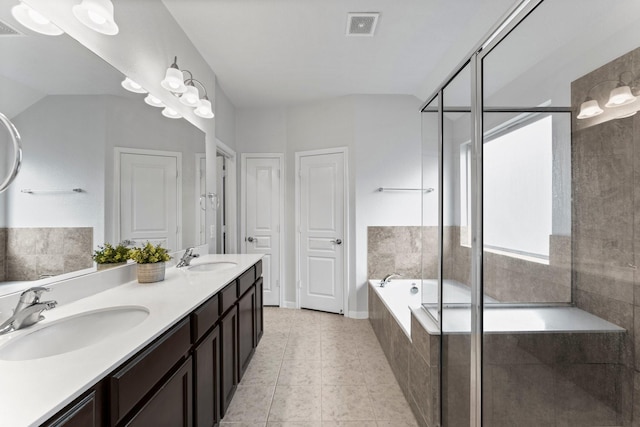 bathroom featuring vanity, independent shower and bath, and tile patterned flooring