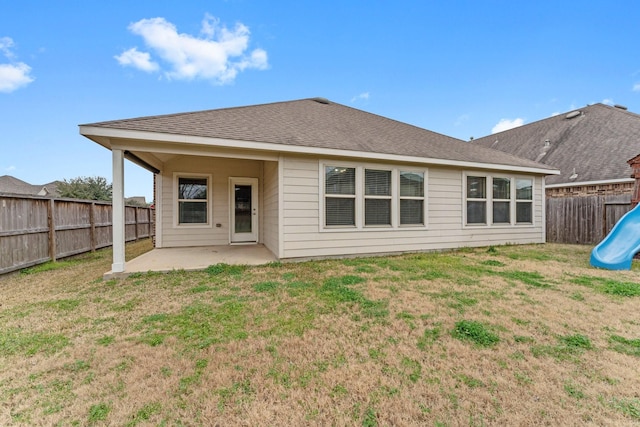 rear view of house featuring a playground, a patio, and a yard