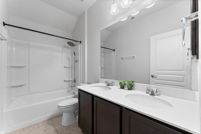 full bathroom featuring washtub / shower combination, vanity, toilet, and tile patterned flooring