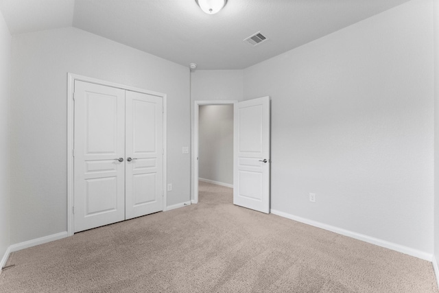 unfurnished bedroom with carpet floors and a closet